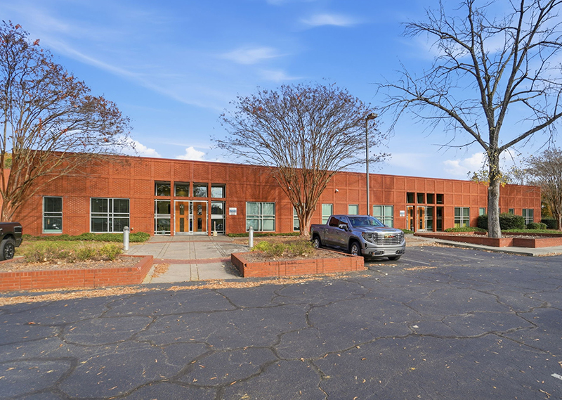 Exterior of a red-brick building in front of a blue sky