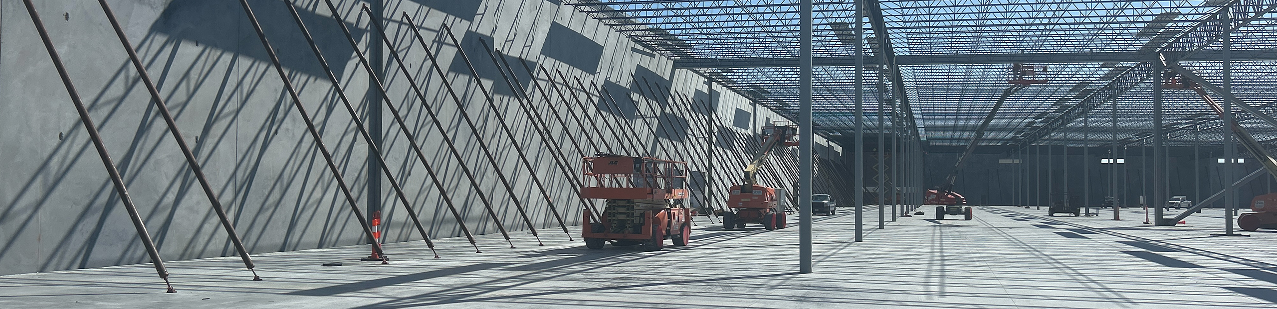 CVP-Development-Contact-2560x621 Interior of a large concrete warehouse under construction